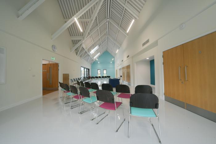 A view of the Main Hall at K2, showing a high barrelled ceiling and multi-coloured chairs.