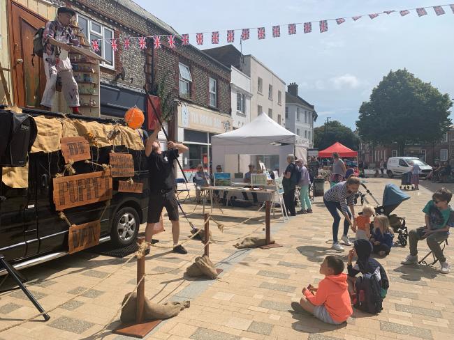 Town Centre event with children watching a puppet show