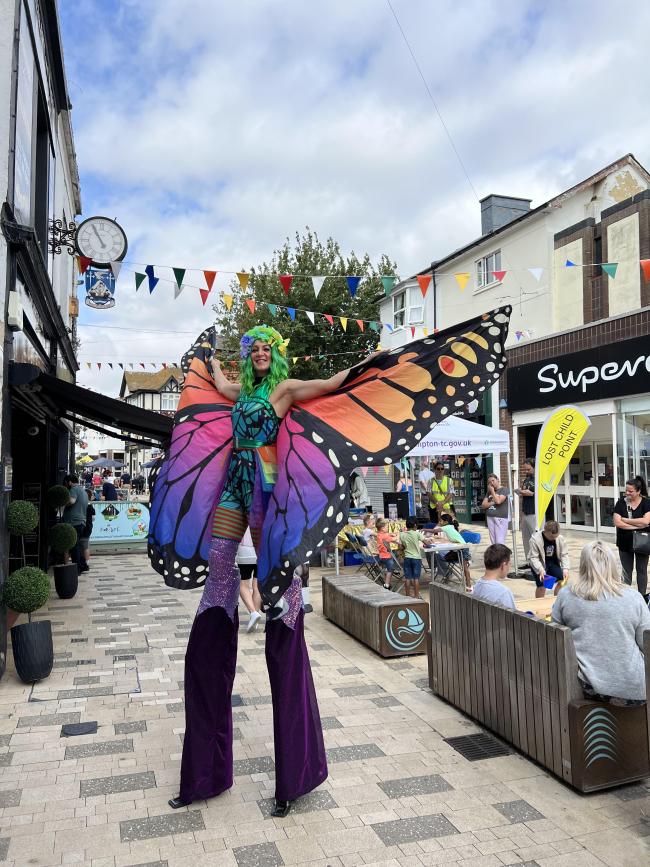 Human butterfly stilt walker from Summer High Street event 2025