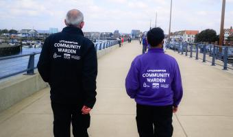 Community Wardens walking along the riverside promenade
