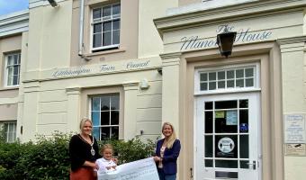 Town Mayor Councillor Michelle Molloy presenting cheque to Treasure Basket outside the Manor House