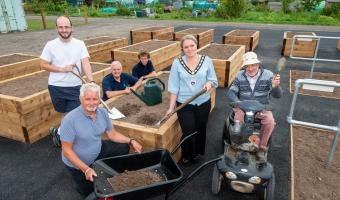Town Mayor Councillor Michelle Molloy with Councillor Tandy, members of the Amenity team and the Allotments Association holding gardening tools in front of an accessible plot